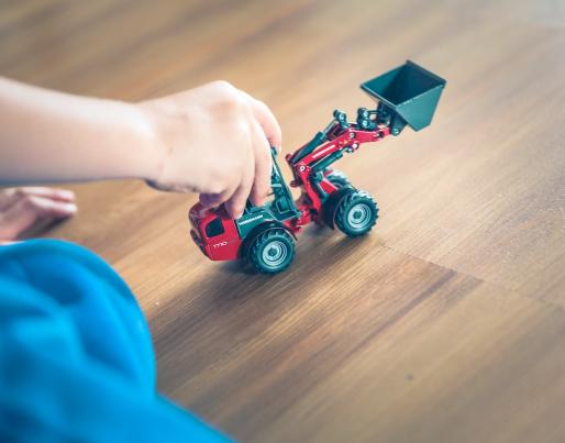 child playing with a toy tractor
