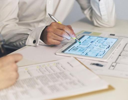 People working together with plans on tablets