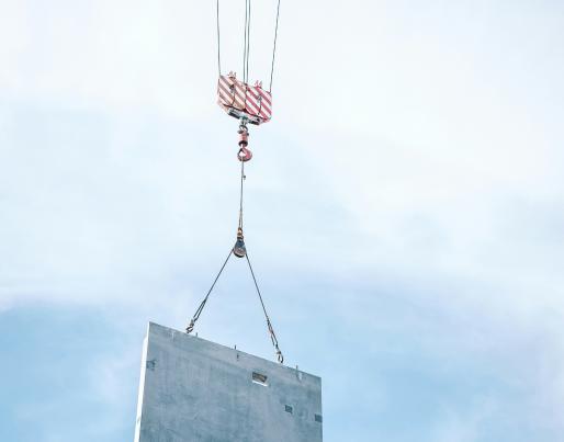 A crane lifting a facade