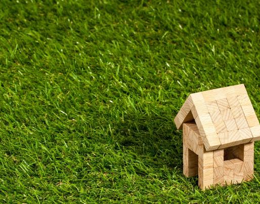 A tiny wooden house on a meadow