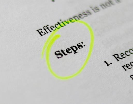 the word "steps" highlighted in a book