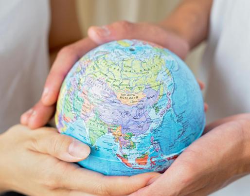 people holding a globe