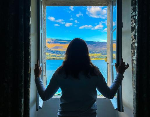 A woman in front of an open window