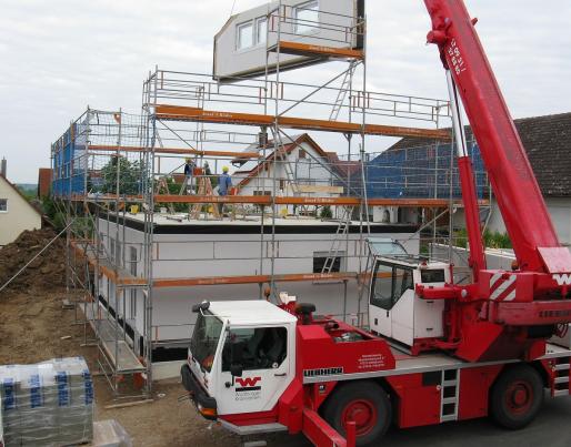 A crane holding a prefabricated facade