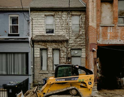 A bulldozer in front of terraced houses