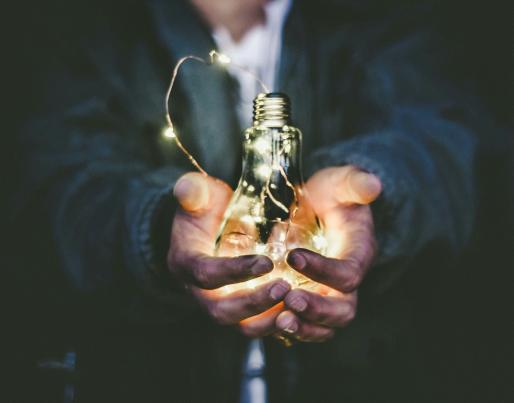 A man holding a light bulb