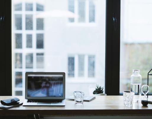 A laptop in front of a window