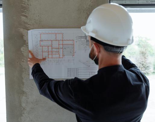 A construction worker consulting a blueprint