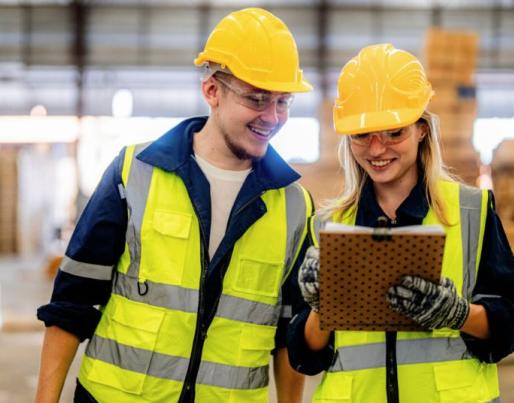 A woman and a man talking at a construction site. 