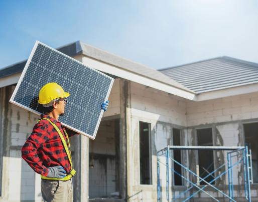 Man with a solar panel in a construction