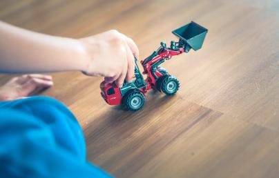child playing with a toy tractor