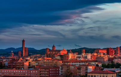 The image shows the skyscraper of a city at sunset