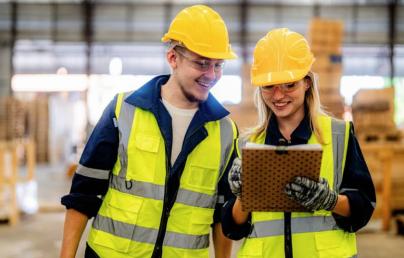 A woman and a man talking at a construction site. 