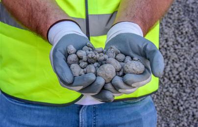 A worker shows pieces of limestone produced using CO2