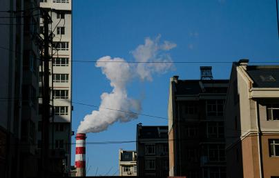 Image of buildings and a chimeney smoking