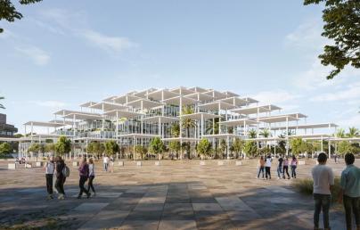 The image depicts a modern architectural structure featuring multiple levels of open, white-framed platforms. The building is surrounded by greenery, including palm trees, with people walking and standing in the foreground on a large paved area.