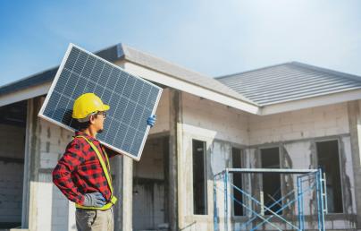 Man with a solar panel in a construction
