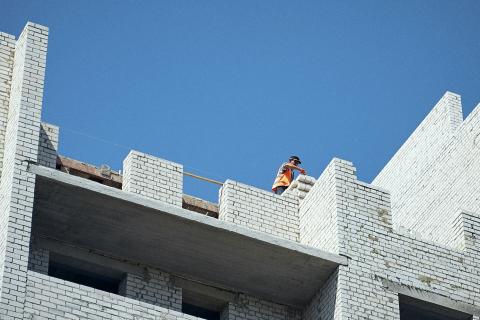 A man working with bricks in a building construction