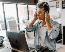 person headphones laptop indoor quality