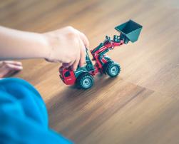 child playing with a toy tractor