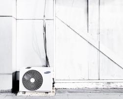 Air conditioner in front of white wall.