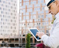 Man looking at tablet on construction site