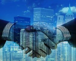 Shaking hands and buildings in the background