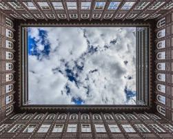 Inner facades of a squared building with open roof to the sky