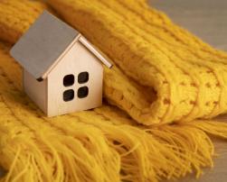 Toy wooden house wrapped in a cover