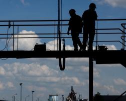 Construction workers in backlight