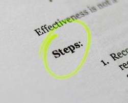 the word "steps" highlighted in a book