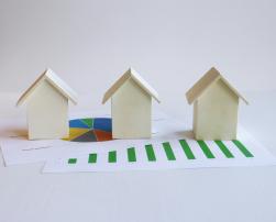 3 little wooden houses on charts