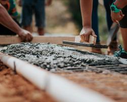 Construction workers lay concrete