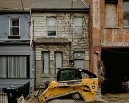 A bulldozer in front of terraced houses