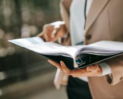 A woman holding a binder