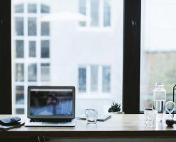 A laptop in front of a window