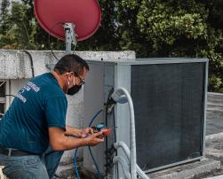 A man checking an air conditioning unit