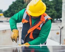 An electrician working on a solar panel
