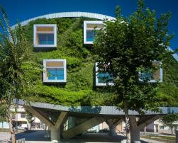 Modern building with curved and green façades