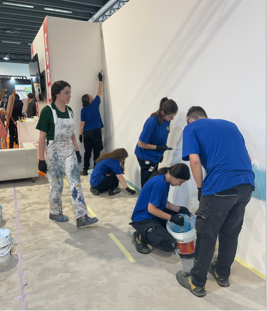 Students participating in a wall decoration activities